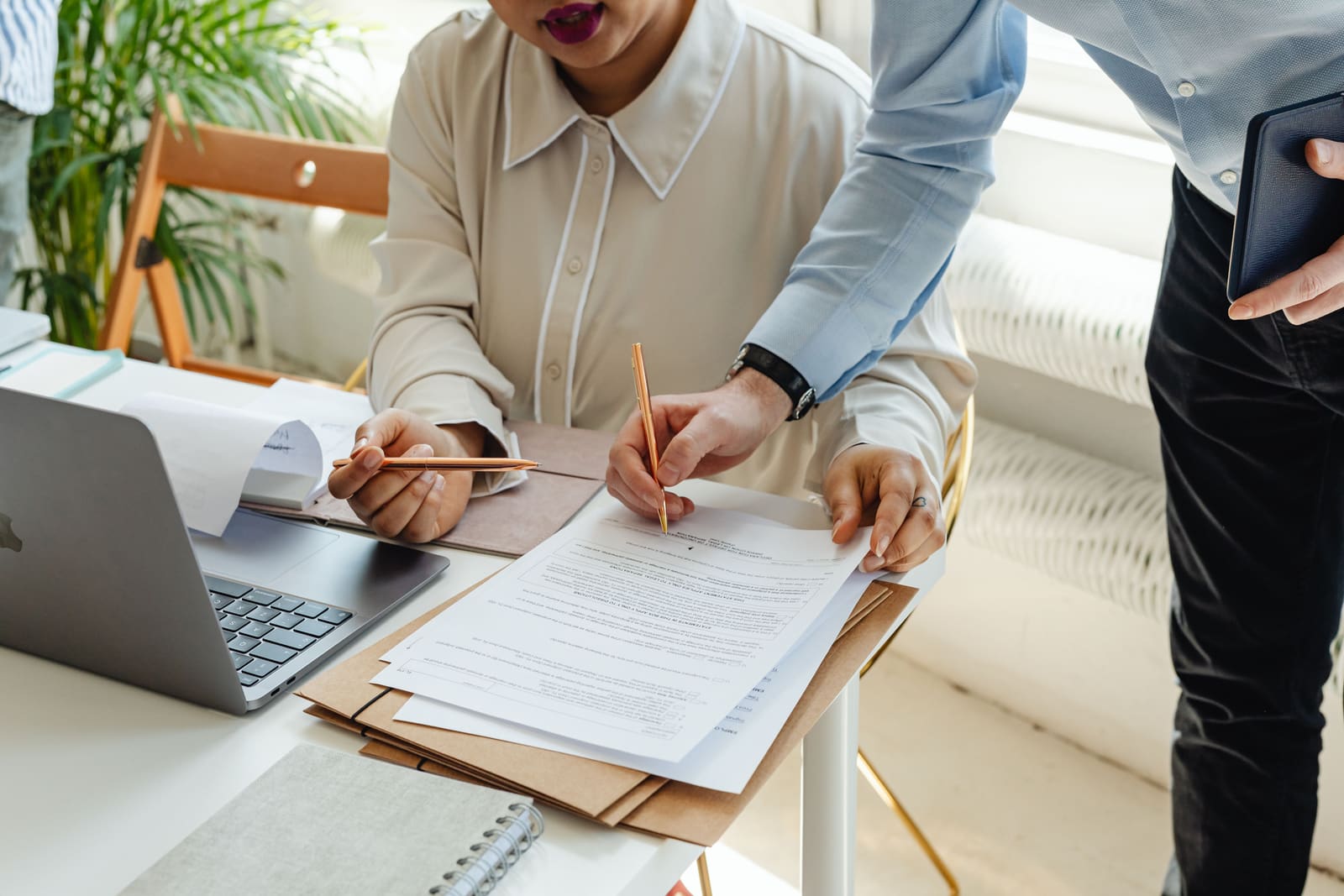 A new employee signing paperwork at a desk