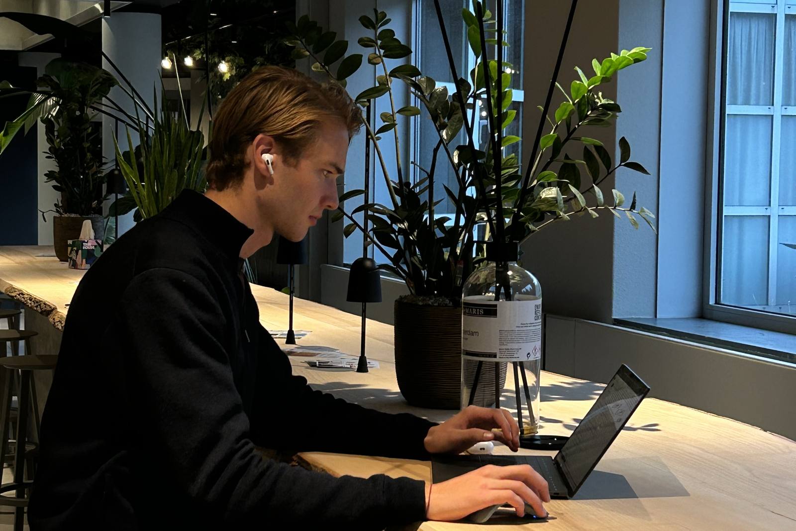 Kasper working on his laptop at a bright desk by the window