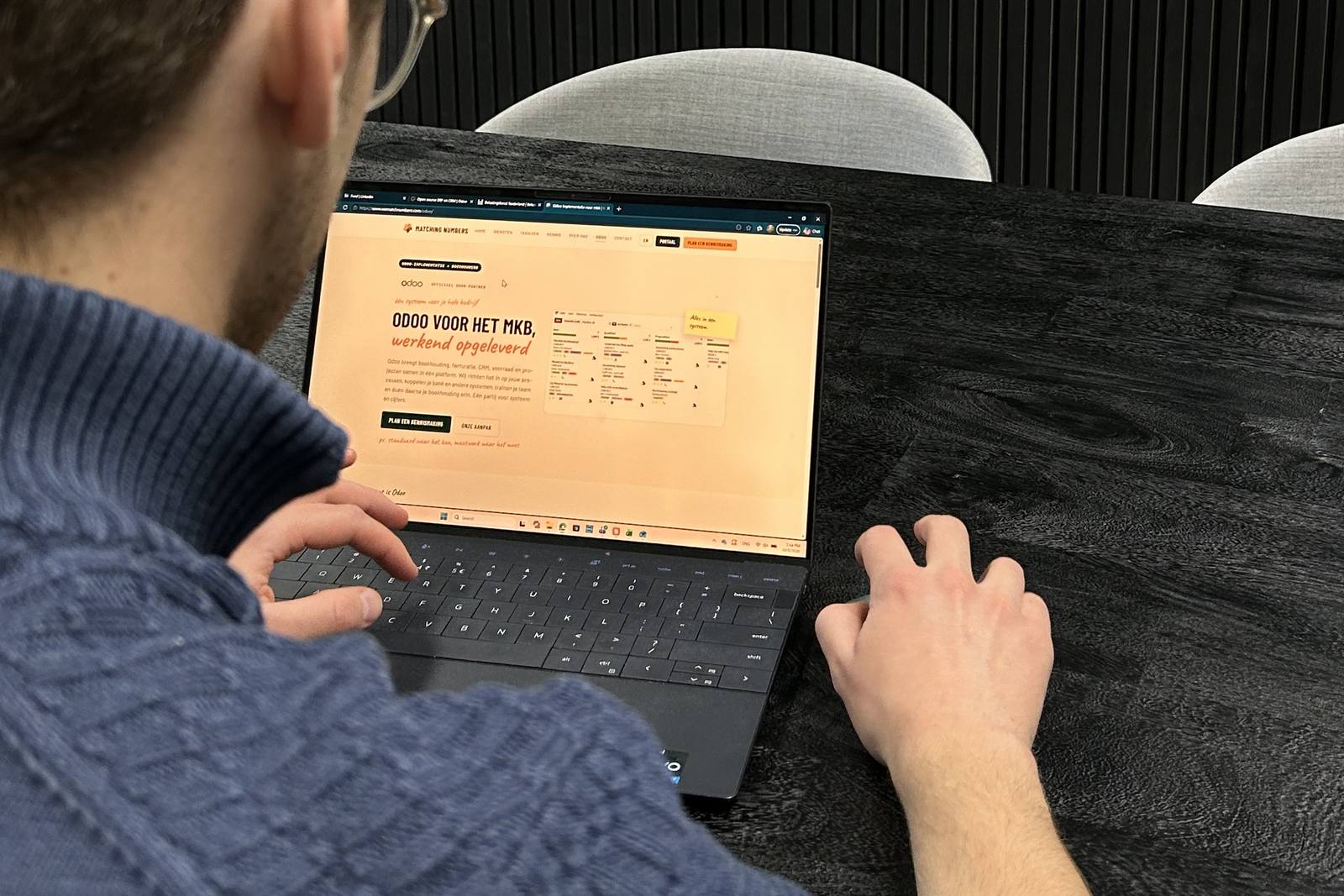 Someone looking at the Matching Numbers Odoo page on a laptop